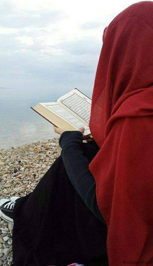 Young beautiful girl reading a holy book of muslim Quran Stock Photo - Alamy